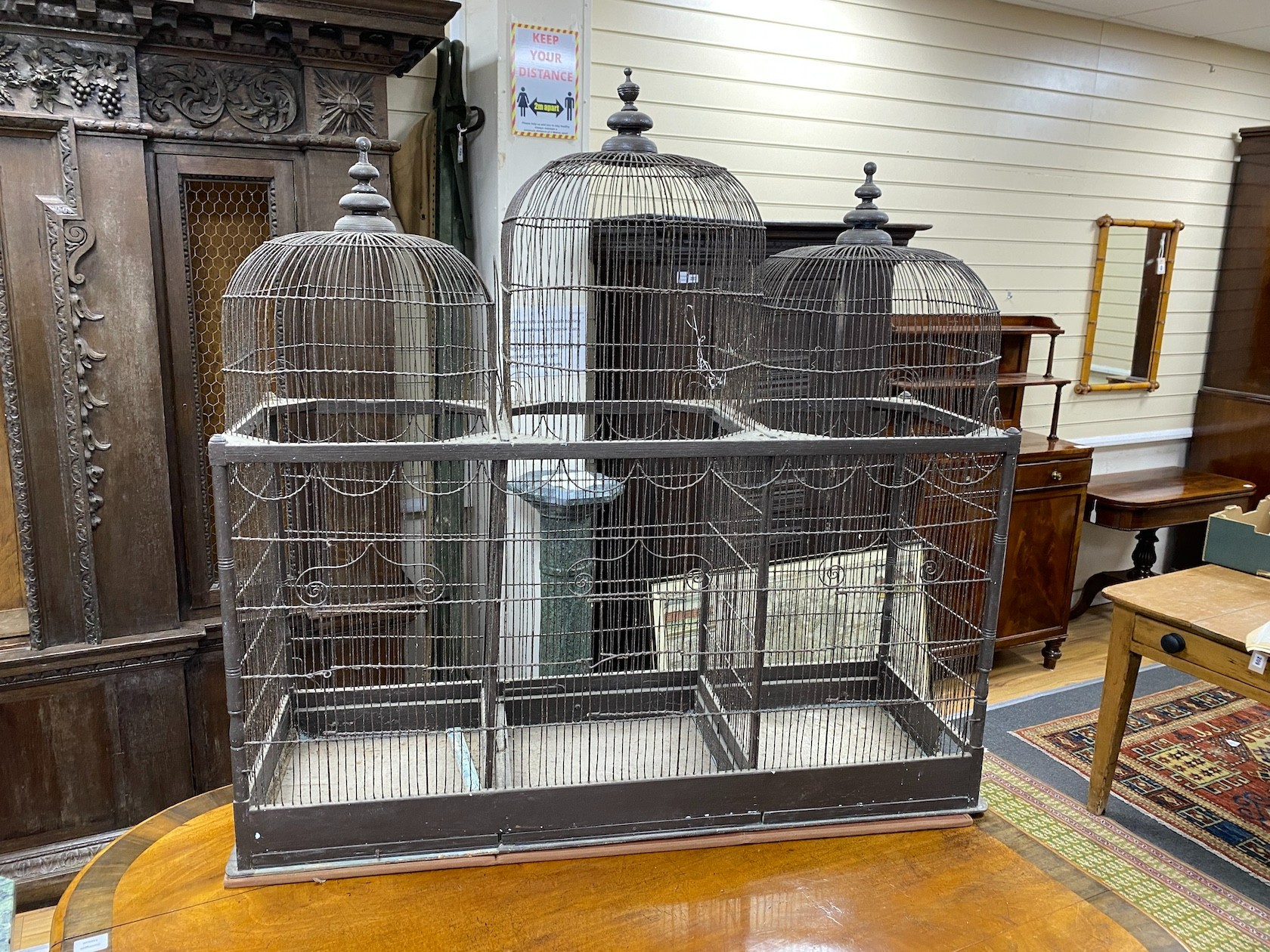An 18th century wire work triple dome canary cage, width 122cm, depth 41cm, height 118cm